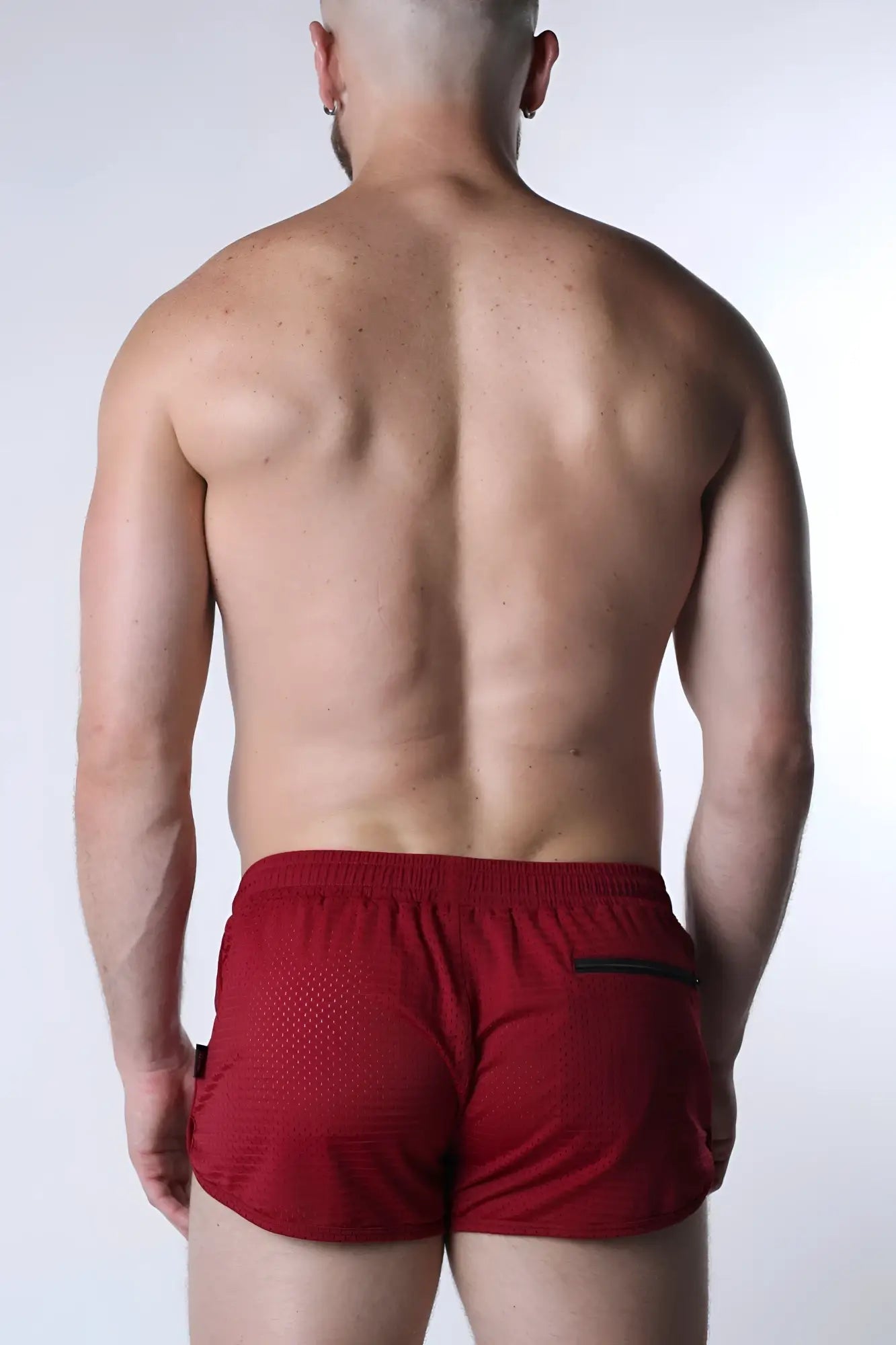 Red starter mesh short with breathable mesh texture and black trim on side pockets for athletic use