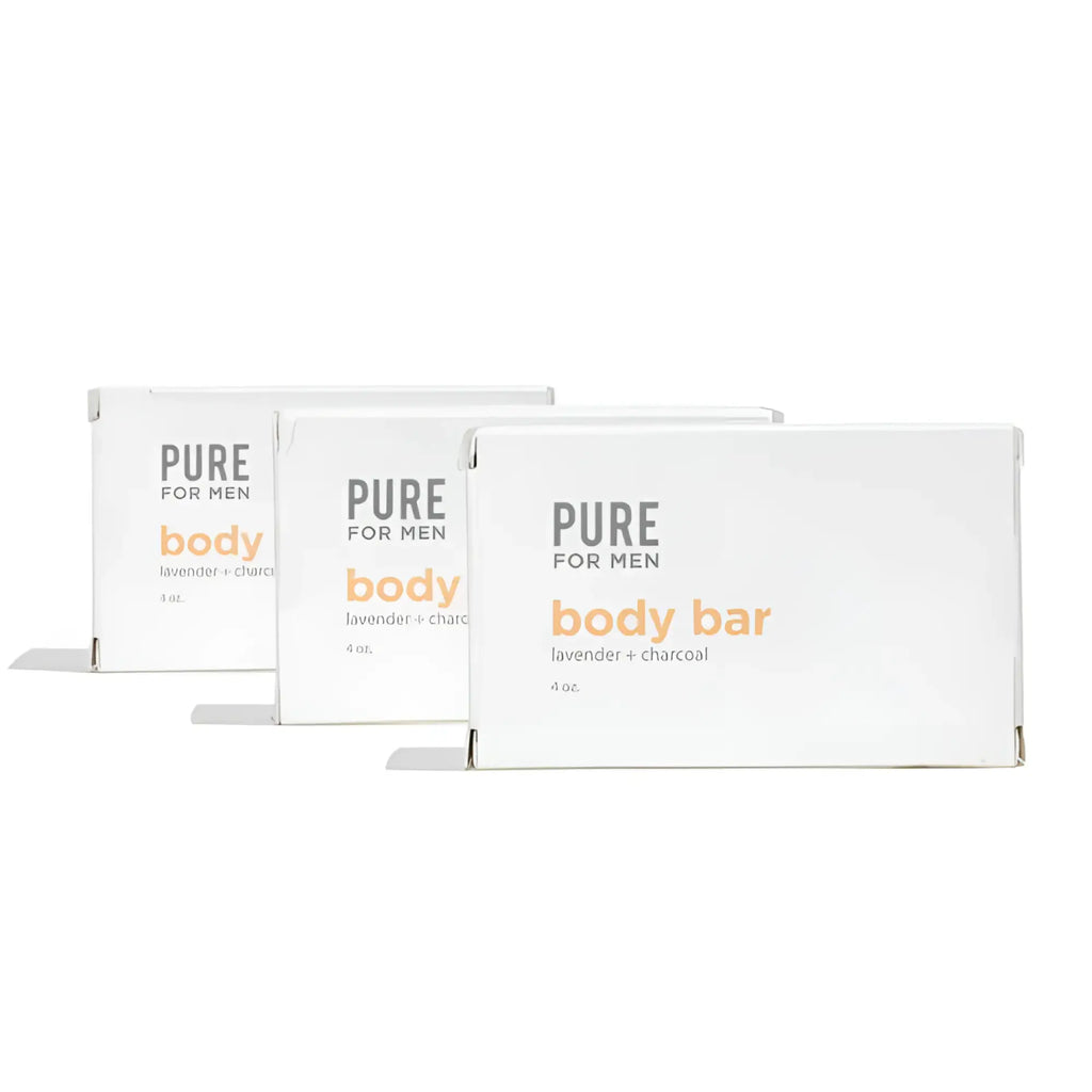 Three white rectangular boxes of pure for men stay ready bar lavender and charcoal body soap with orange and gray text