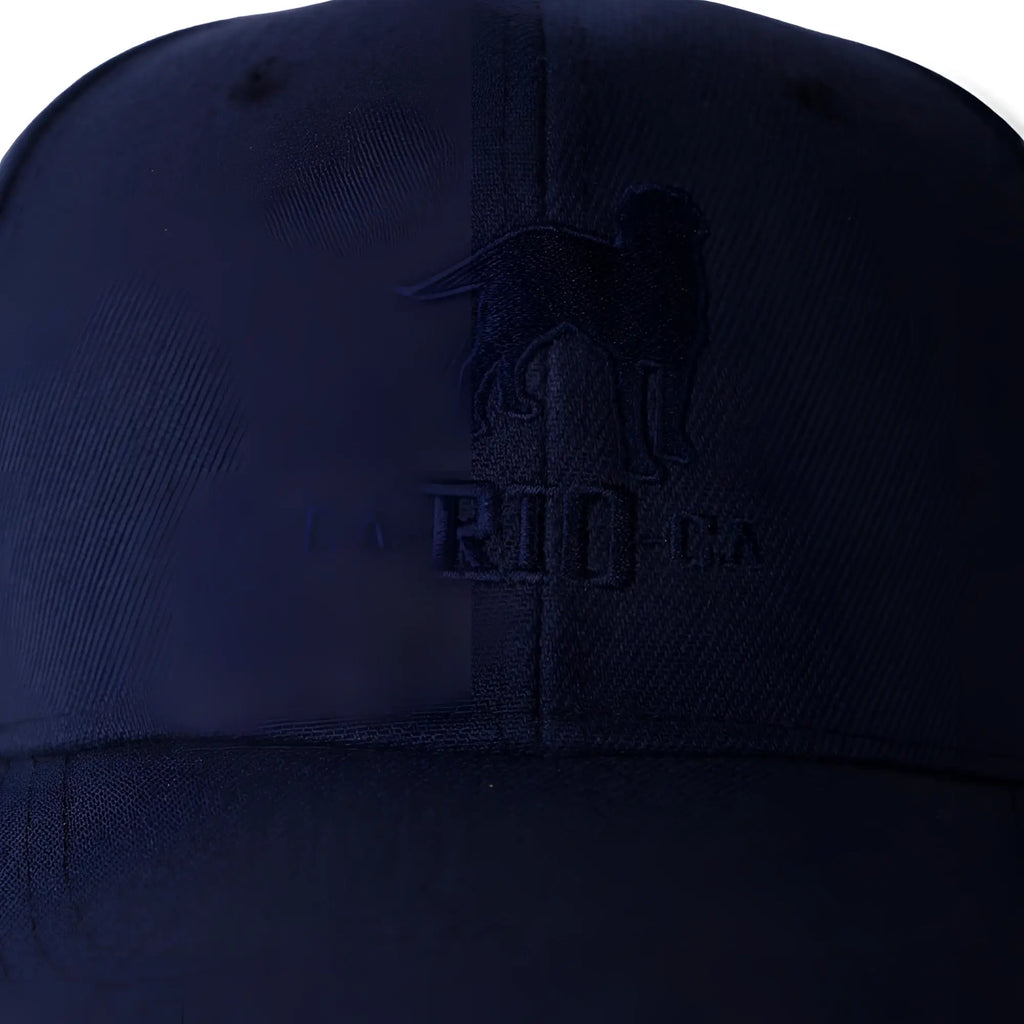 Dark navy blue baseball cap with embroidered dog silhouette above the ca-rio-ca logo in The Stealth design