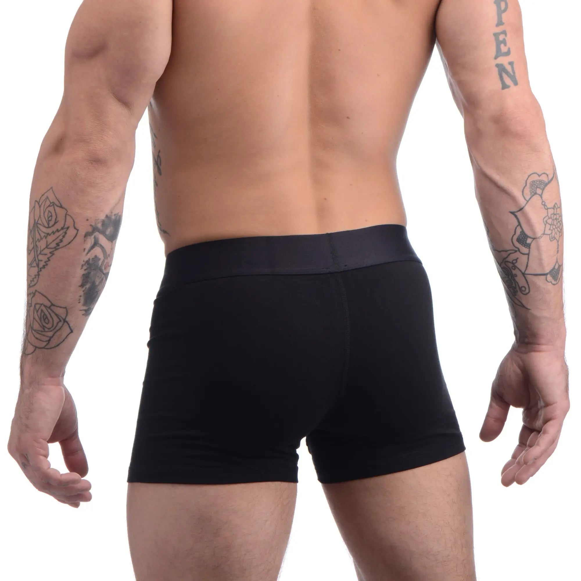 Back view of a muscular man wearing black Strap U Incognito boxer briefs with a hidden O-ring.