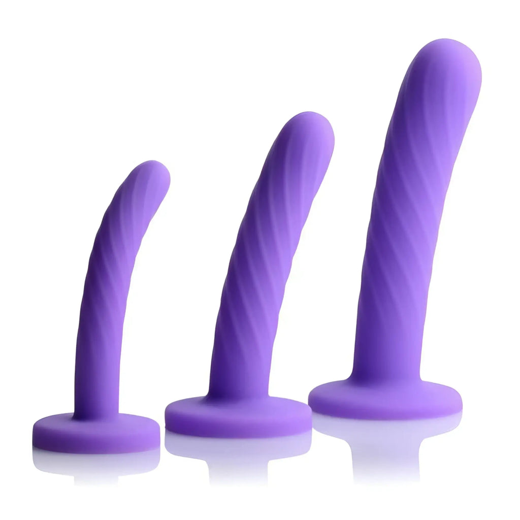 Strap U Tri-Play 3-piece silicone dildo set featuring purple, spiraled, flared-base dildos in three different sizes.