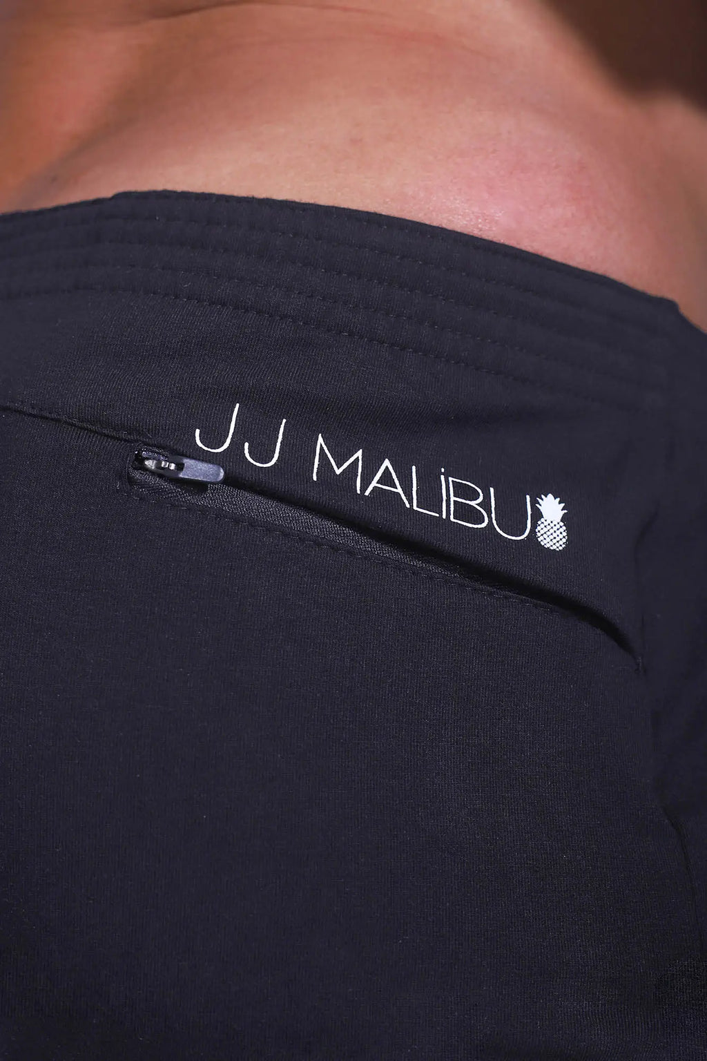 Black jj malibu stretch-it 2 inch athletic shorts in midnight black with white logo and zipper detail