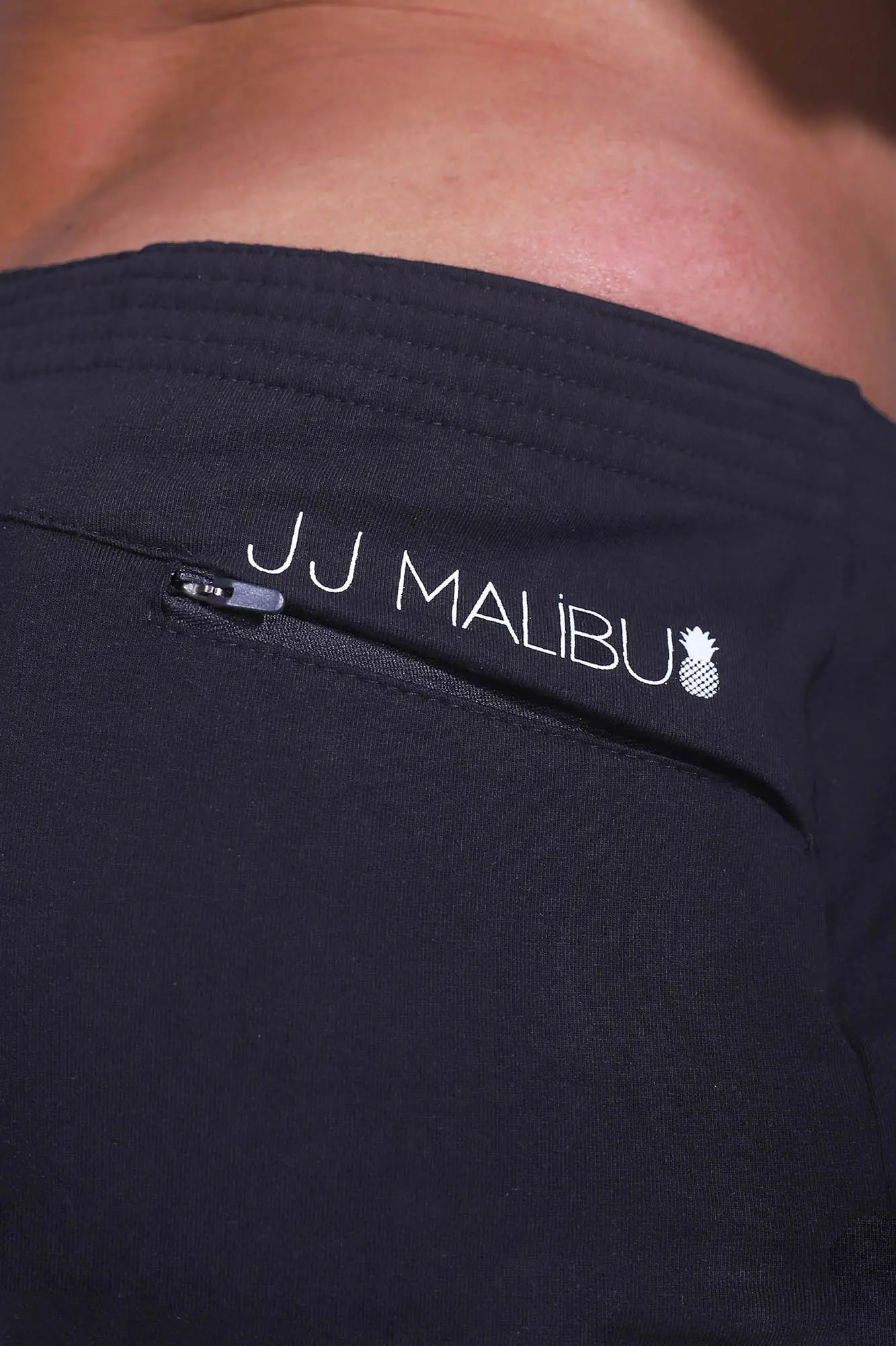 Black jj malibu stretch-it 2 inch athletic shorts in midnight black with white logo and zipper detail