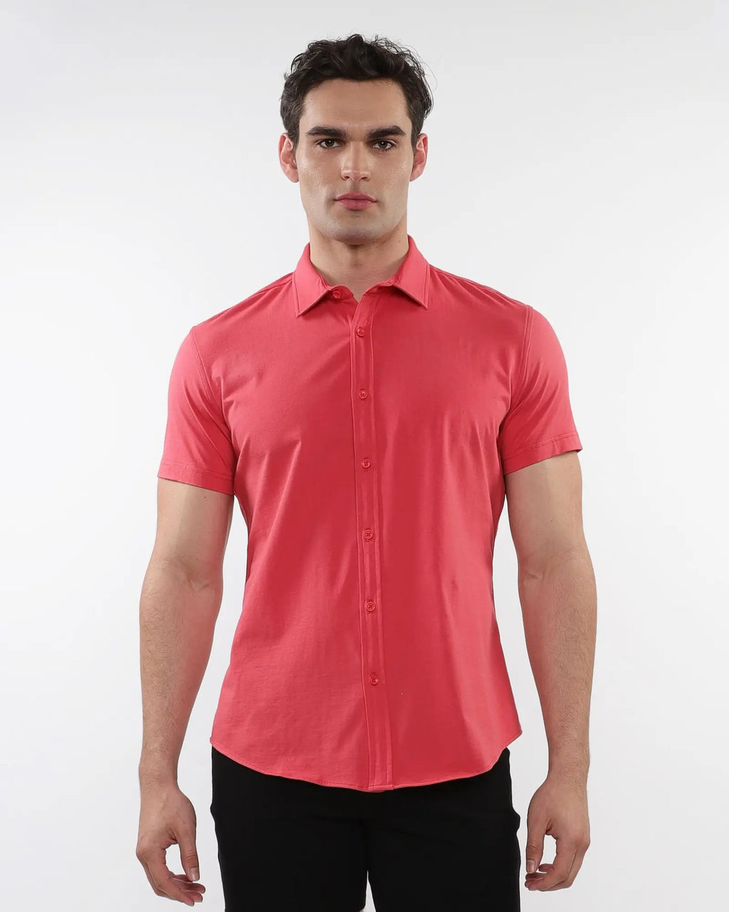 A crisp coral-colored stretch knit shirt with short sleeves, classic collar, and neat button-down details