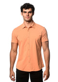 A sleek peach-colored stretch knit short-sleeved button-up shirt with a classic collar and tailored fit