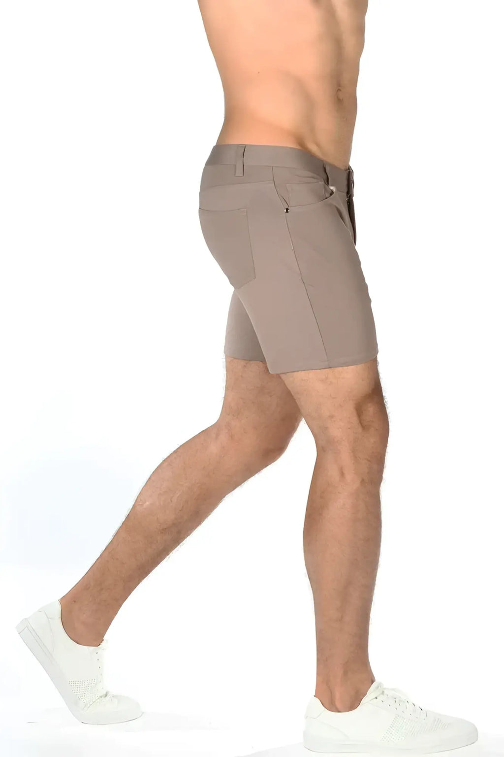 Beige stretch knit shorts with sleek modern design and subtle stitching details for athletic use