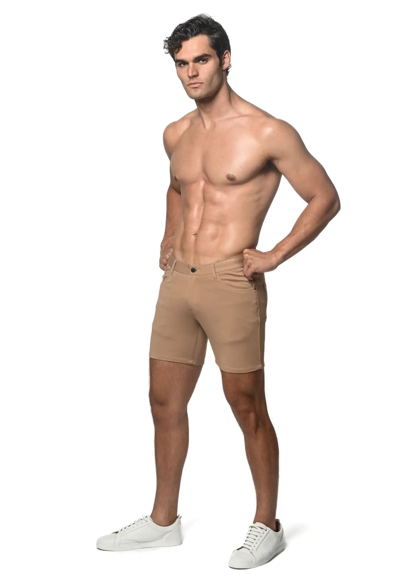 Beige stretch knit athletic shorts with tailored fit and classic five-pocket design for comfortable activewear