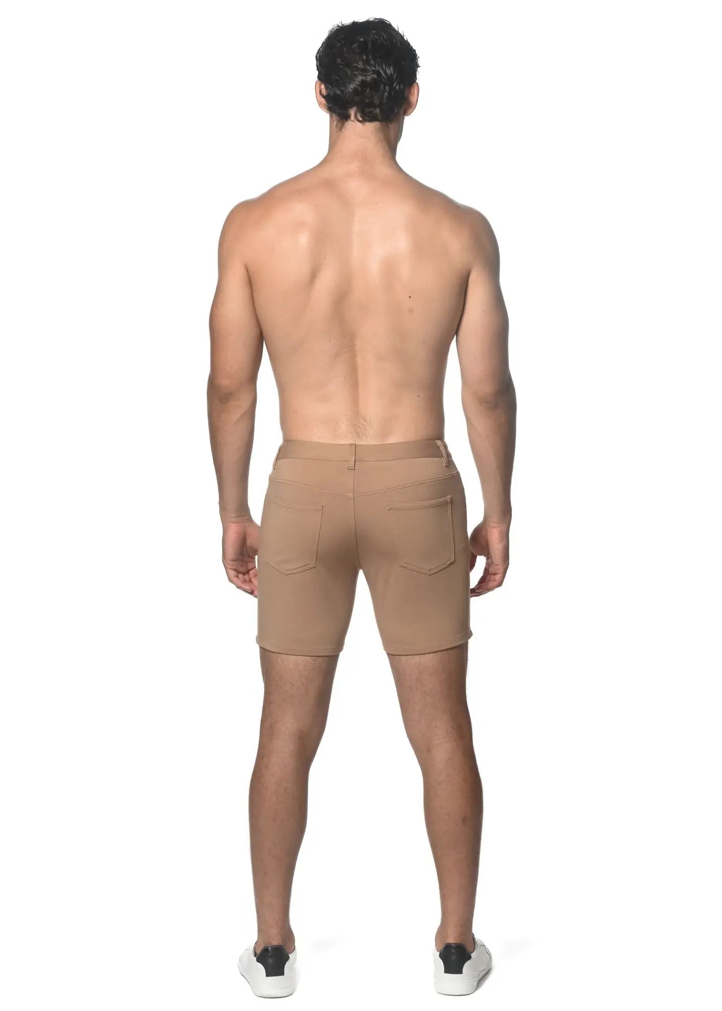 Beige stretch knit chino shorts with tailored fit and two rear pockets shown from the back side