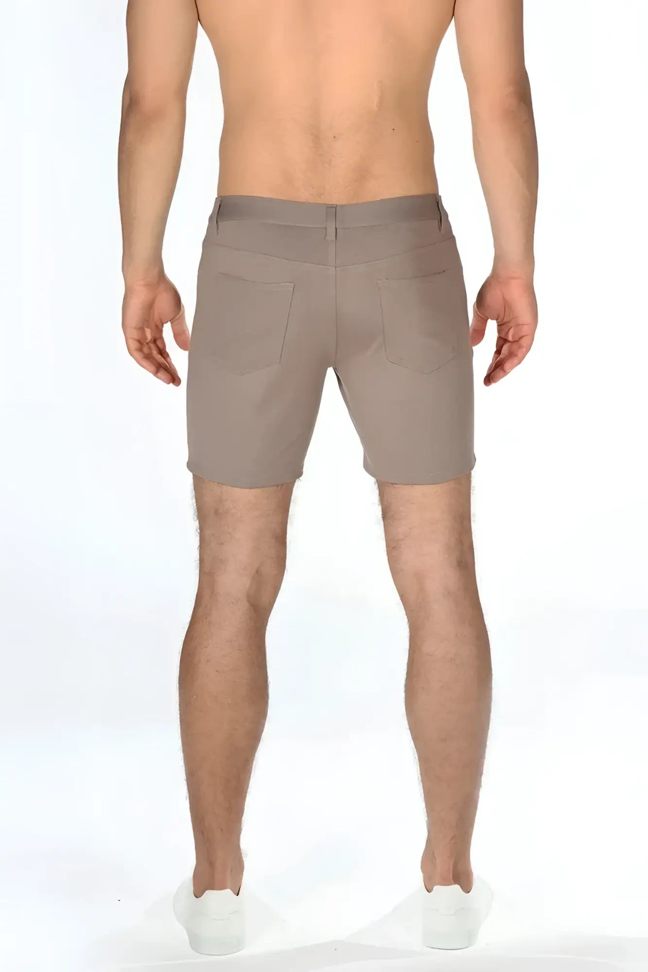 Beige stretch knit shorts with tailored fit and two rear pockets shown from the back side