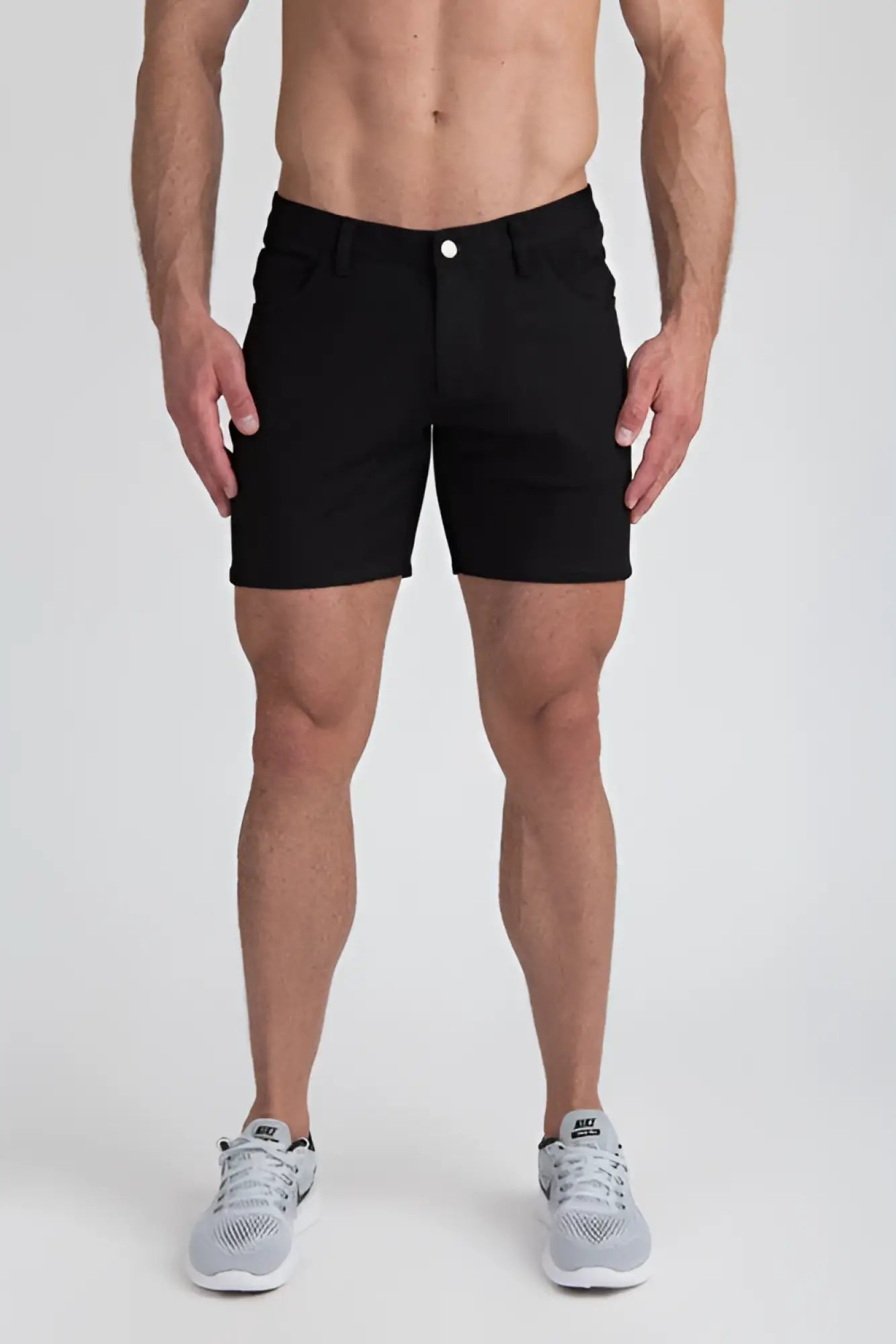Black men’s stretch knit shorts with classic five-pocket design and single white button closure