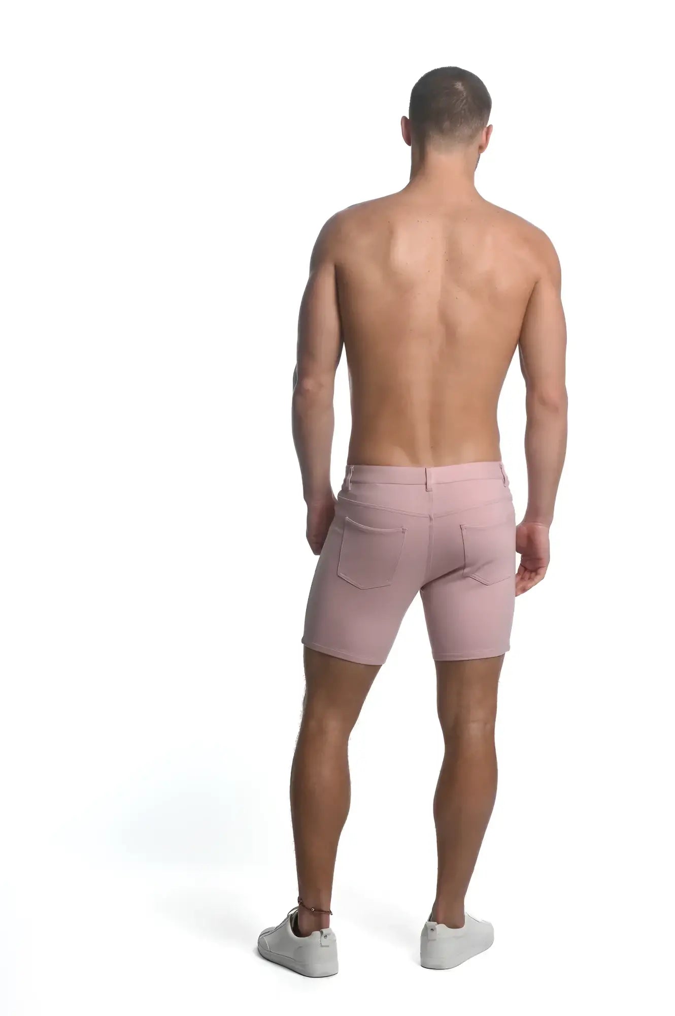 A pair of men’s pink stretch knit denim shorts with classic five-pocket design and belt loops