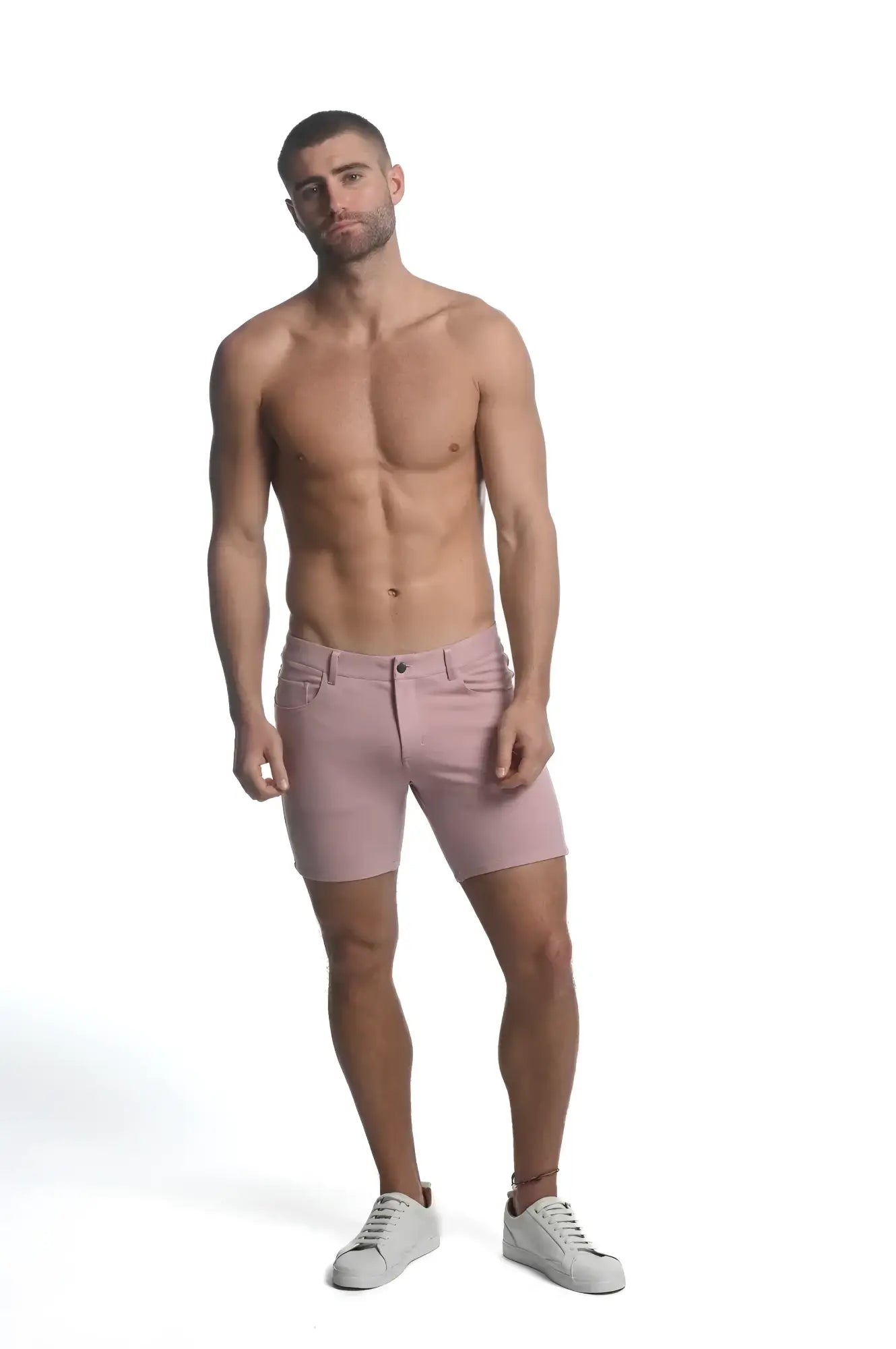 A pair of tailored fit pink stretch knit shorts for men with a classic five-pocket design