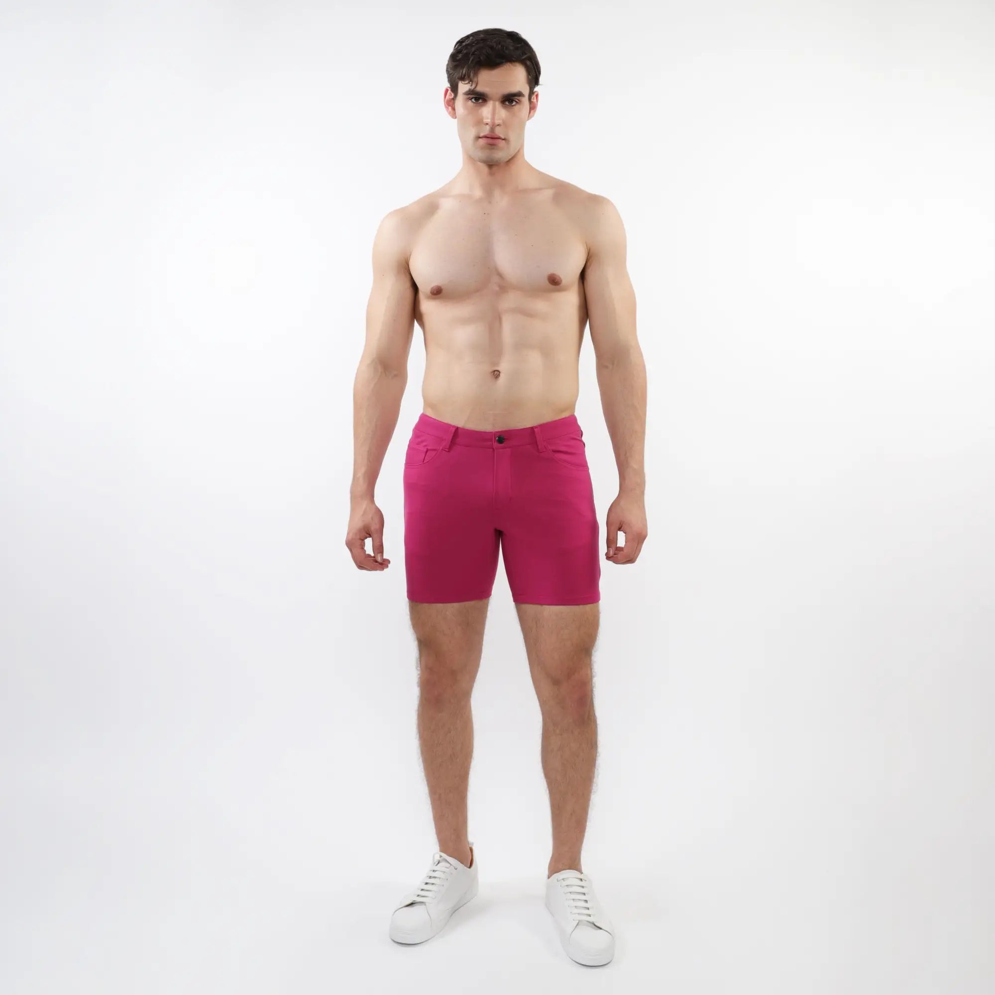 A pair of vibrant fuchsia stretch knit shorts with a sleek modern design and subtle stitching details