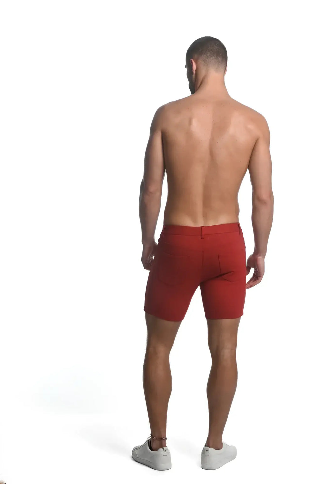 Back view of red stretch knit athletic shorts with tailored fit and visible back pockets