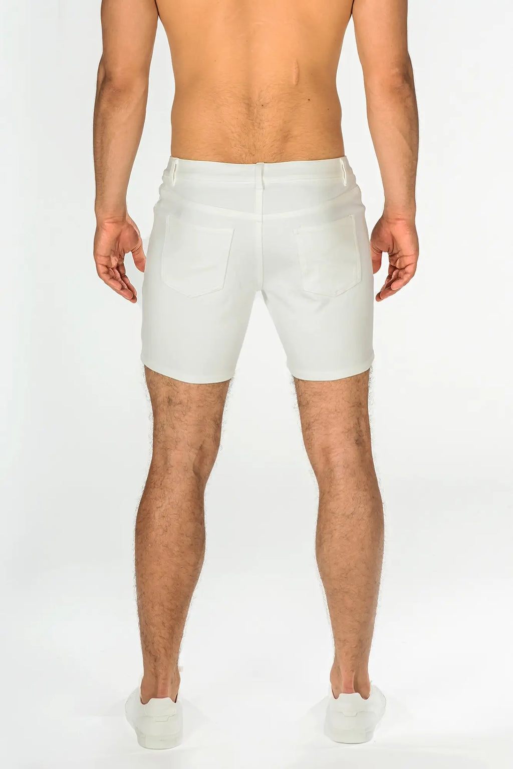White stretch knit shorts with a tailored fit and classic back pockets shown from the back side
