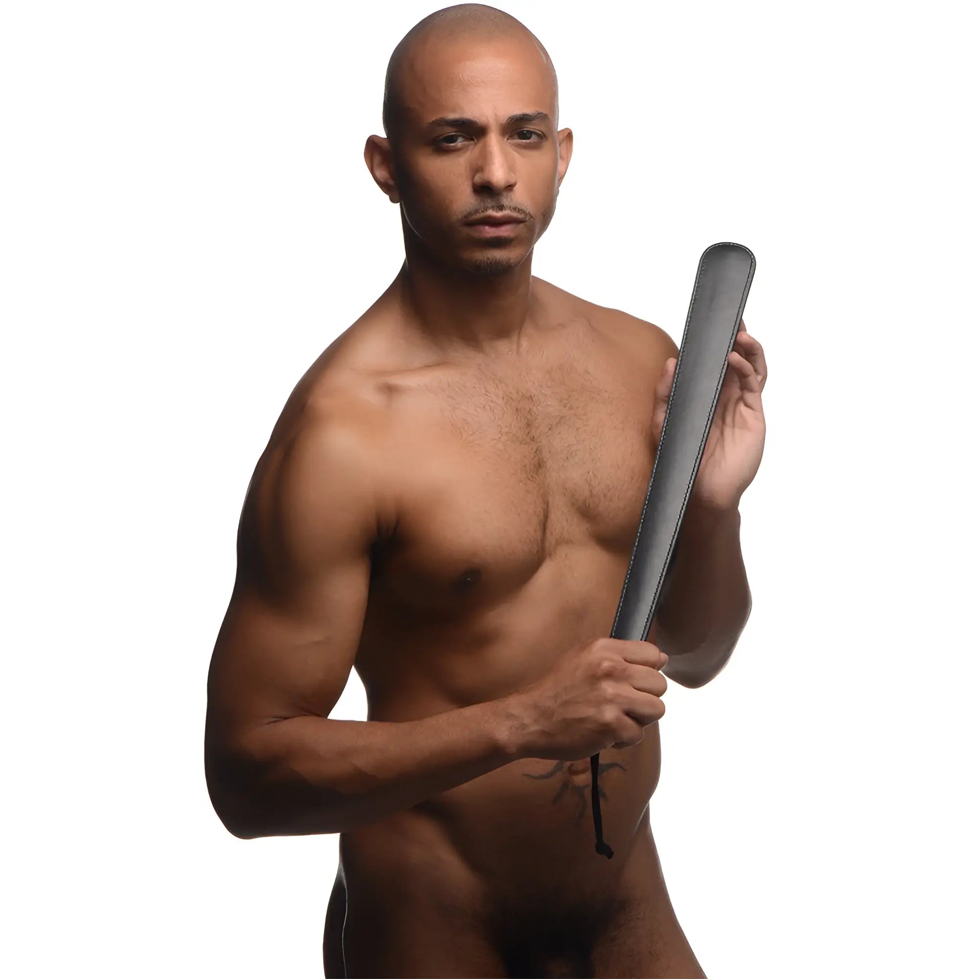 A shirtless man holds a long, black Strict 19 Inch Slapper paddle with stitched edges against a white background.