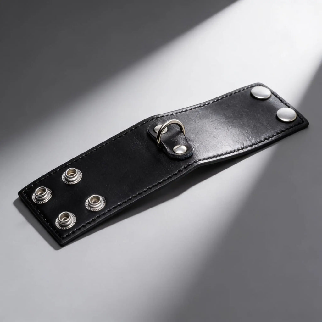 Strict 2 Inch black leather ball stretcher featuring a silver D-ring and secure metal snap button closures.