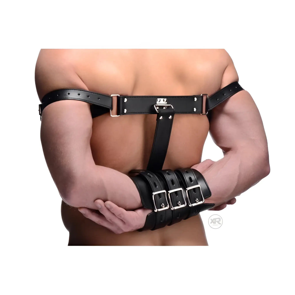 Strict Armbinder: A black leather harness and cuff system restraining a person’s arms behind their back.