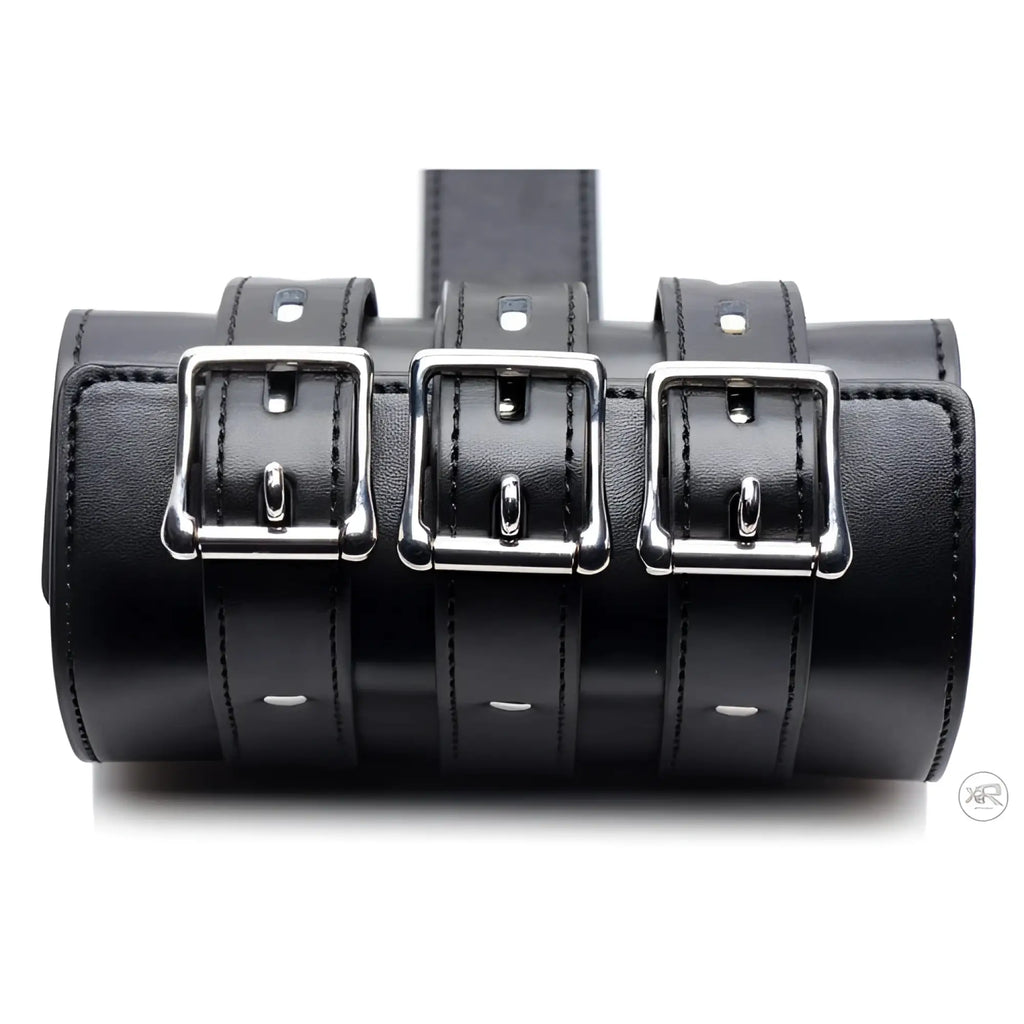 Strict Armbinder made of black leather with three polished silver buckles and adjustable straps.