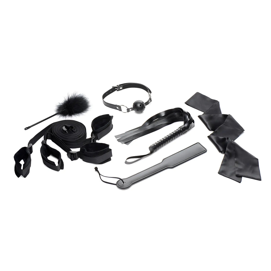 Strict Bed Restraint Bondage Kit: A set of black leather and fabric sensory play accessories on a white background.