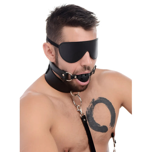 Strict Deluxe 10 Piece Bondage Set: A man wearing a black leather blindfold, collar, and ball gag against white.