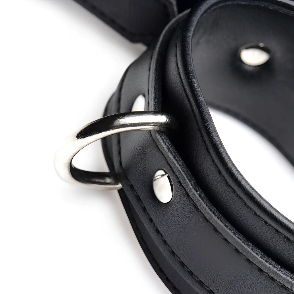 Strict Frog Tie Restraint Set in black faux leather with silver metal D-rings and rivets, isolated on white.