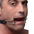 Strict Hook Claw Mouth Spreader: Silver metal hooks attached to a black strap, holding a person's mouth wide open.