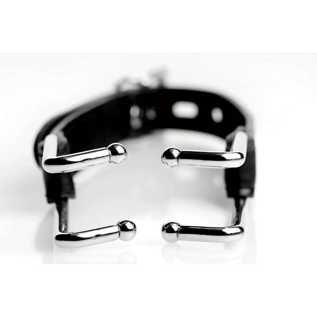 Strict Hook Claw Mouth Spreader featuring a black leather strap with four silver, L-shaped metal hook attachments.