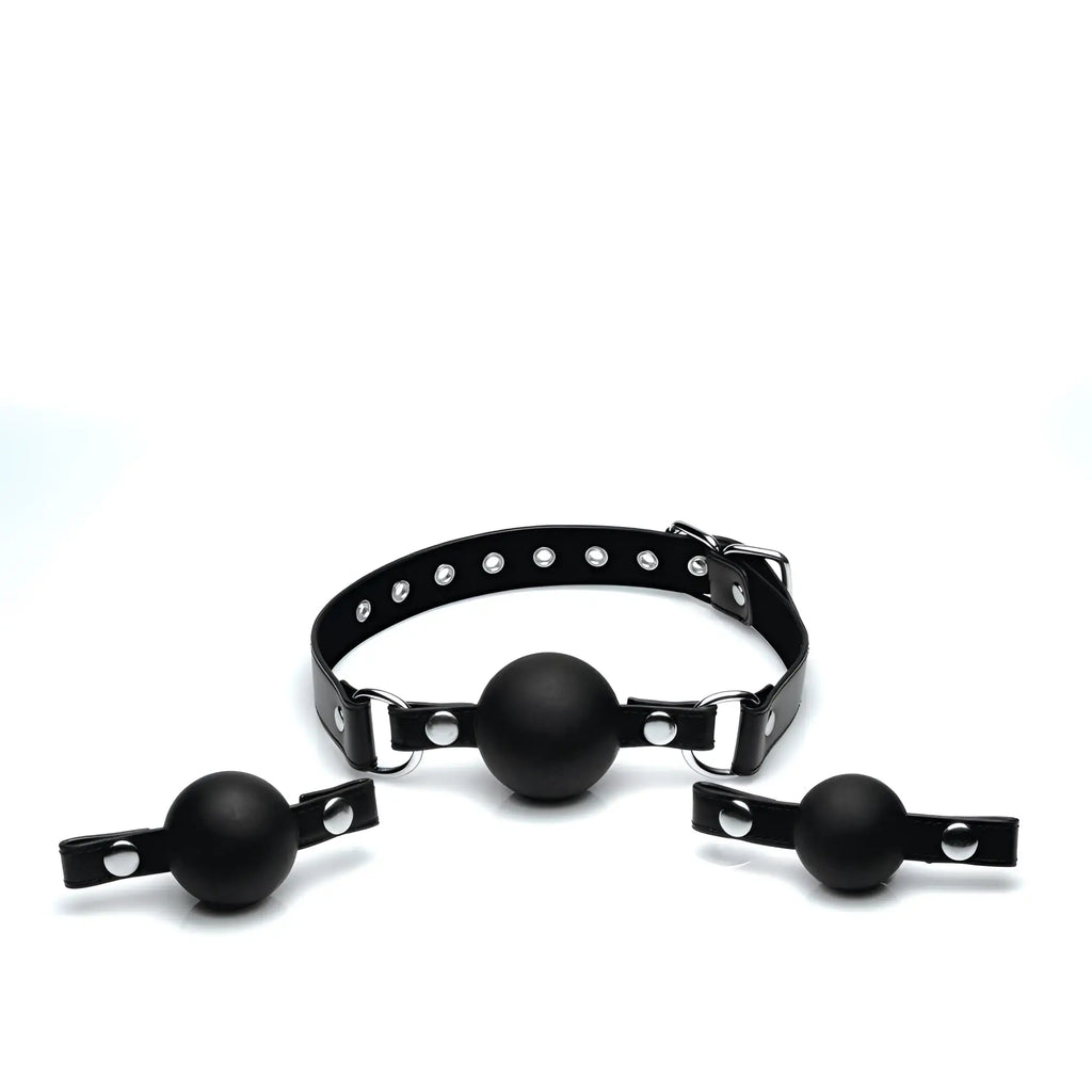 Strict Interchangeable Silicone Ball Gag Set featuring a black buckled collar and three matte black silicone gag spheres.