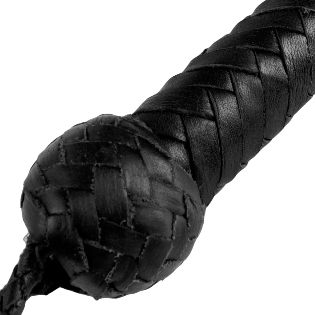 Close-up of a black Strict Leather 4 Foot Whip, featuring a woven leather handle with a detailed knot pommel.