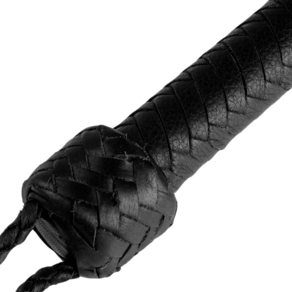 Strict Leather 5 Foot Bullwhip: A close-up of a black, hand-braided leather handle with a detailed knot and wrist loop.