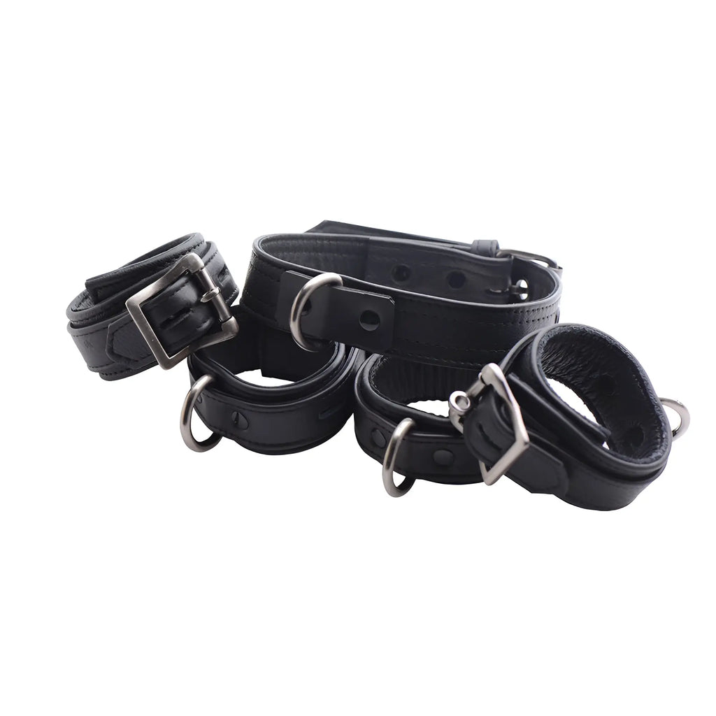 Strict Leather black premium leather collar and cuffs set with metal buckles and D-ring accents on a white background.