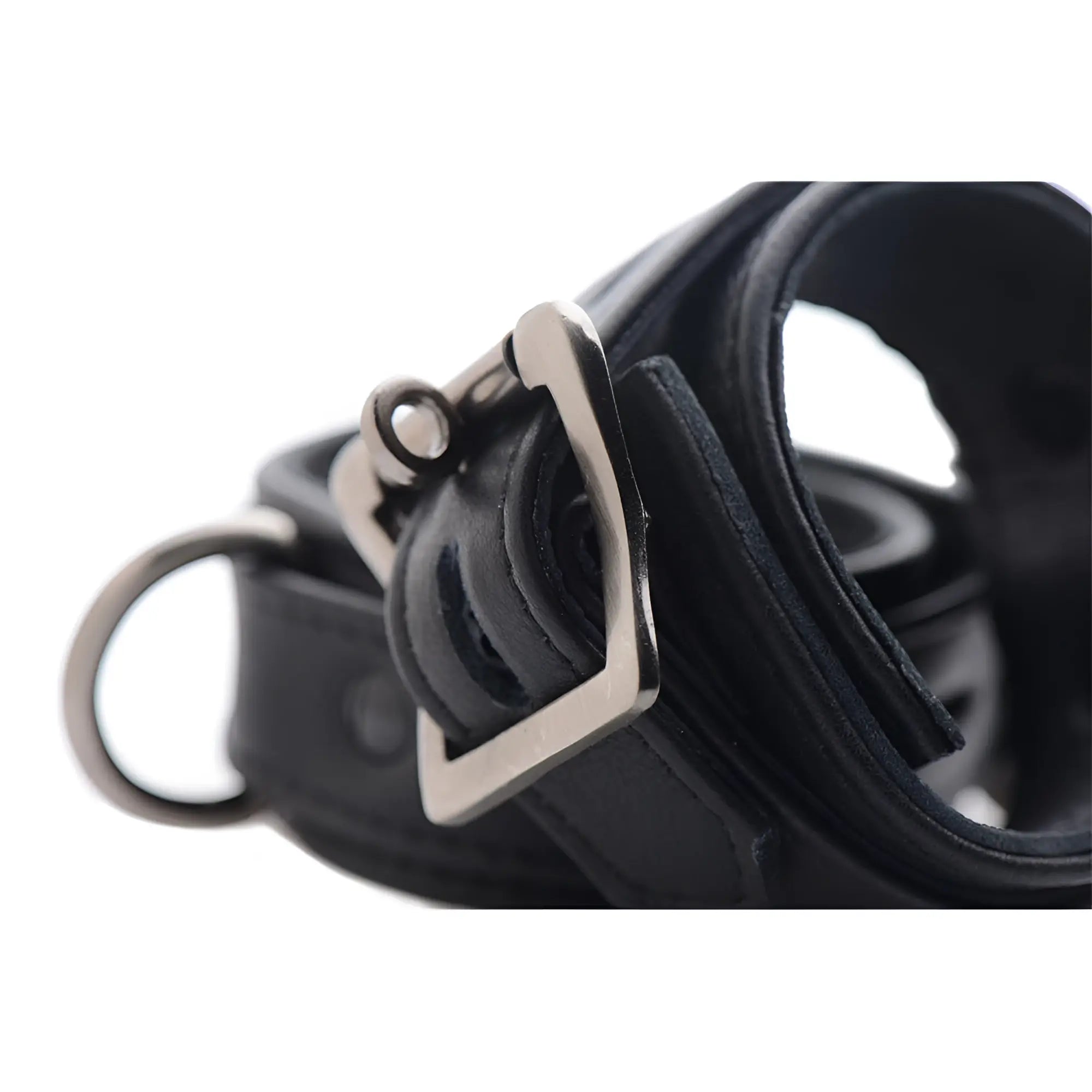 Strict Leather black premium leather cuff featuring a silver-toned metal buckle and D-ring against a white background.