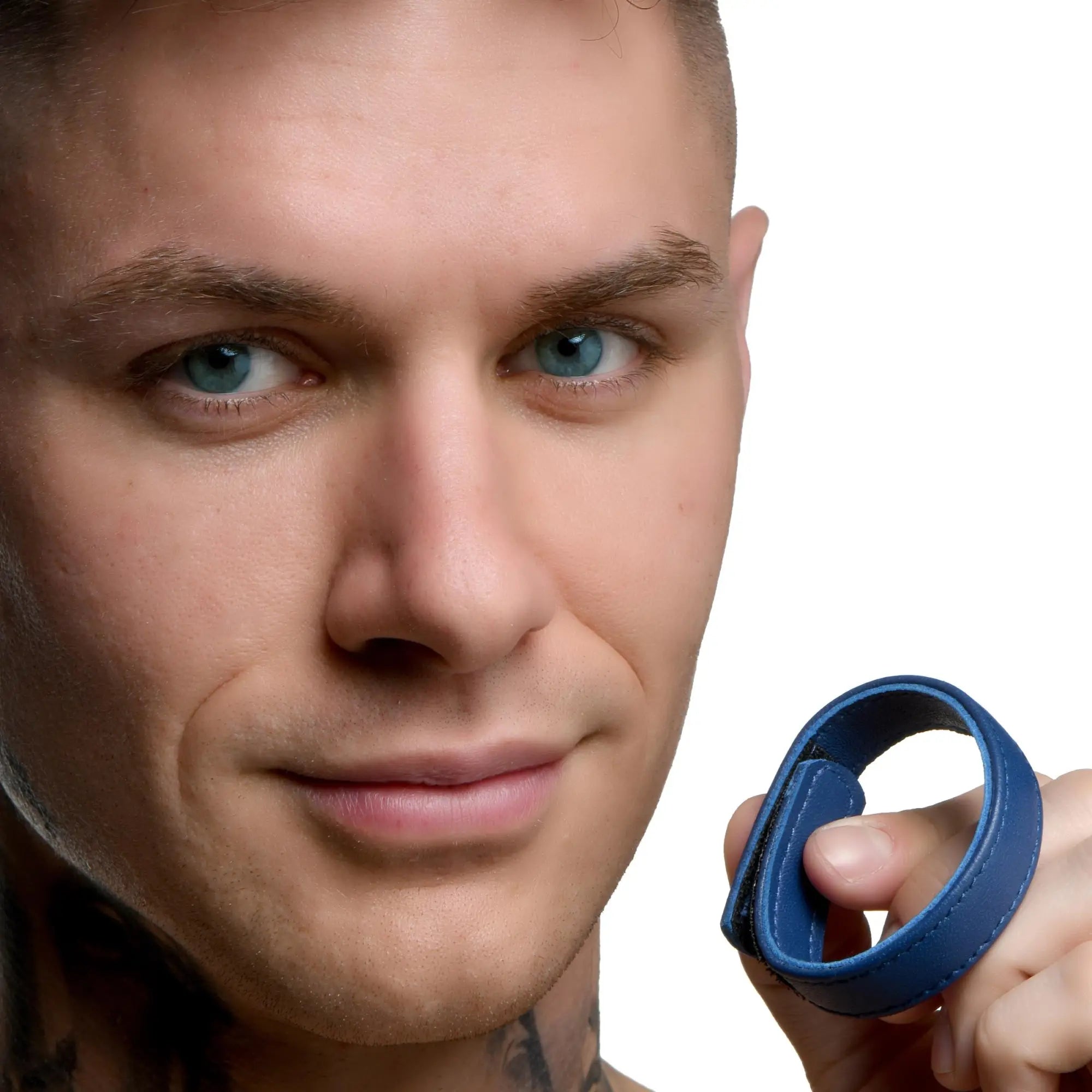 Man holding a blue leather cock ring with velcro closure.