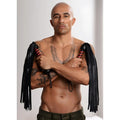 Strict Leather Bullhide Flogger: A shirtless man holds two black and red-striped leather floggers with arms crossed.
