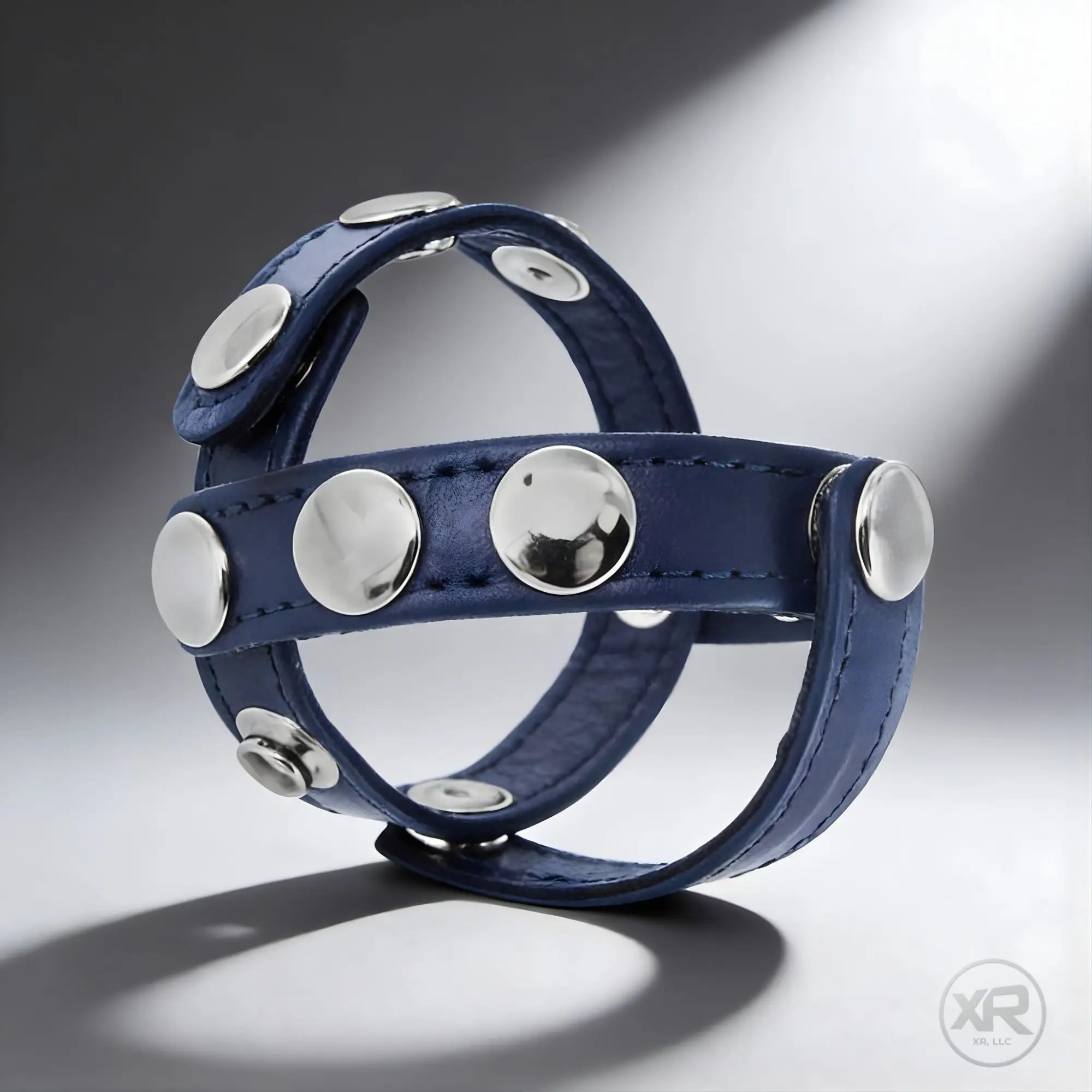 Strict Leather cobalt blue leather cock and ball harness with silver studs.