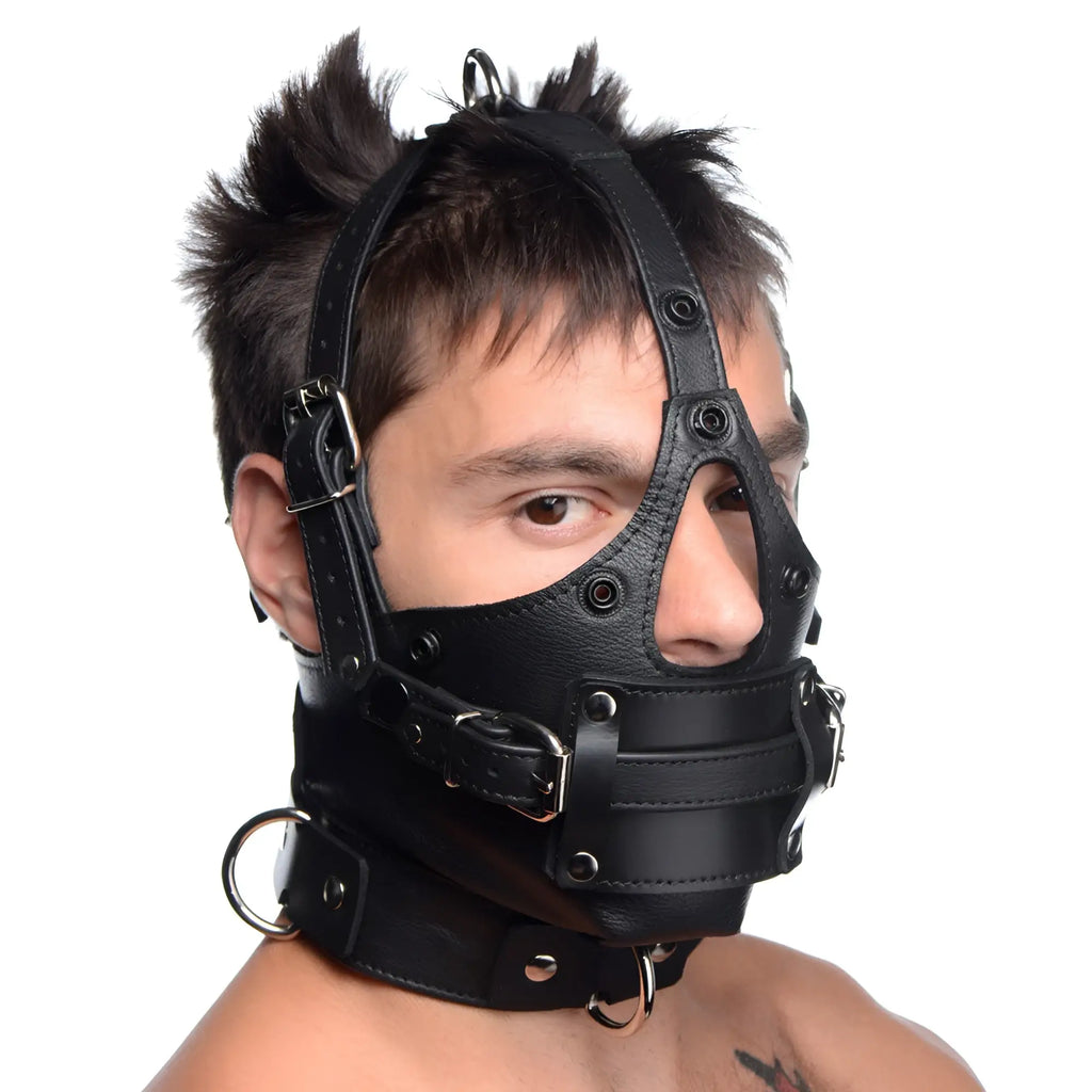 Strict Leather black head harness with removable gag, featuring adjustable buckles, metal rings, and eye/nose cutouts.