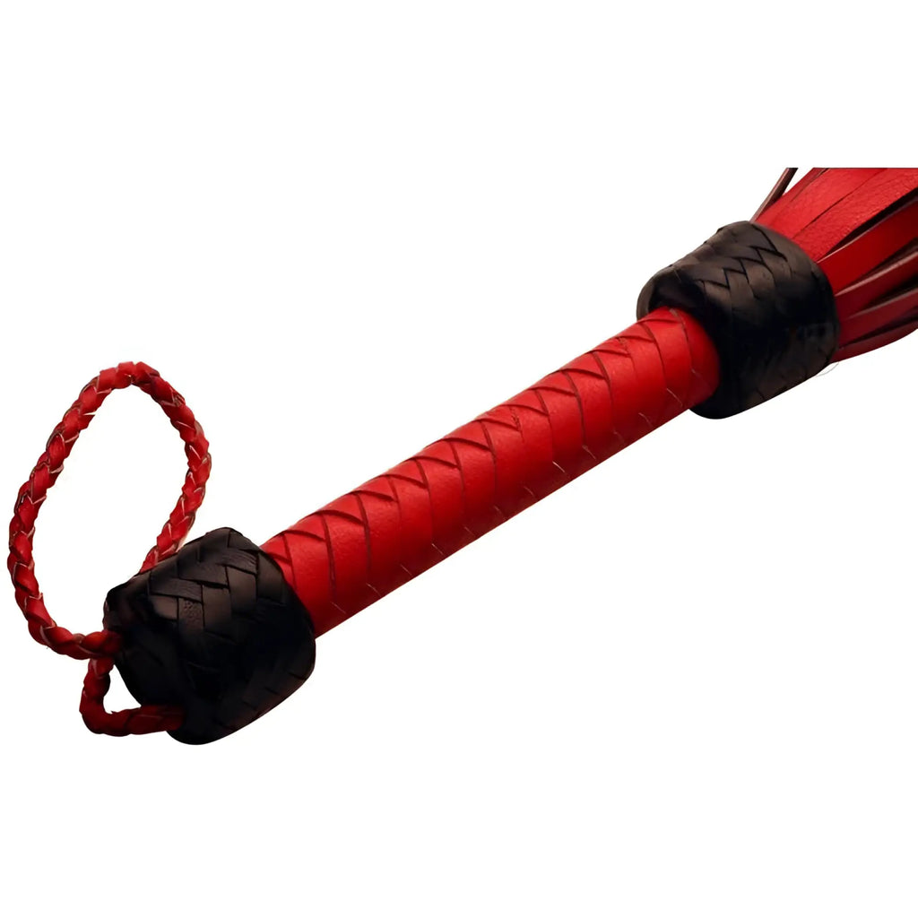 Strict Leather The Heavy Tail Flogger with red leather handle, braided black accents, and a matching wrist loop.