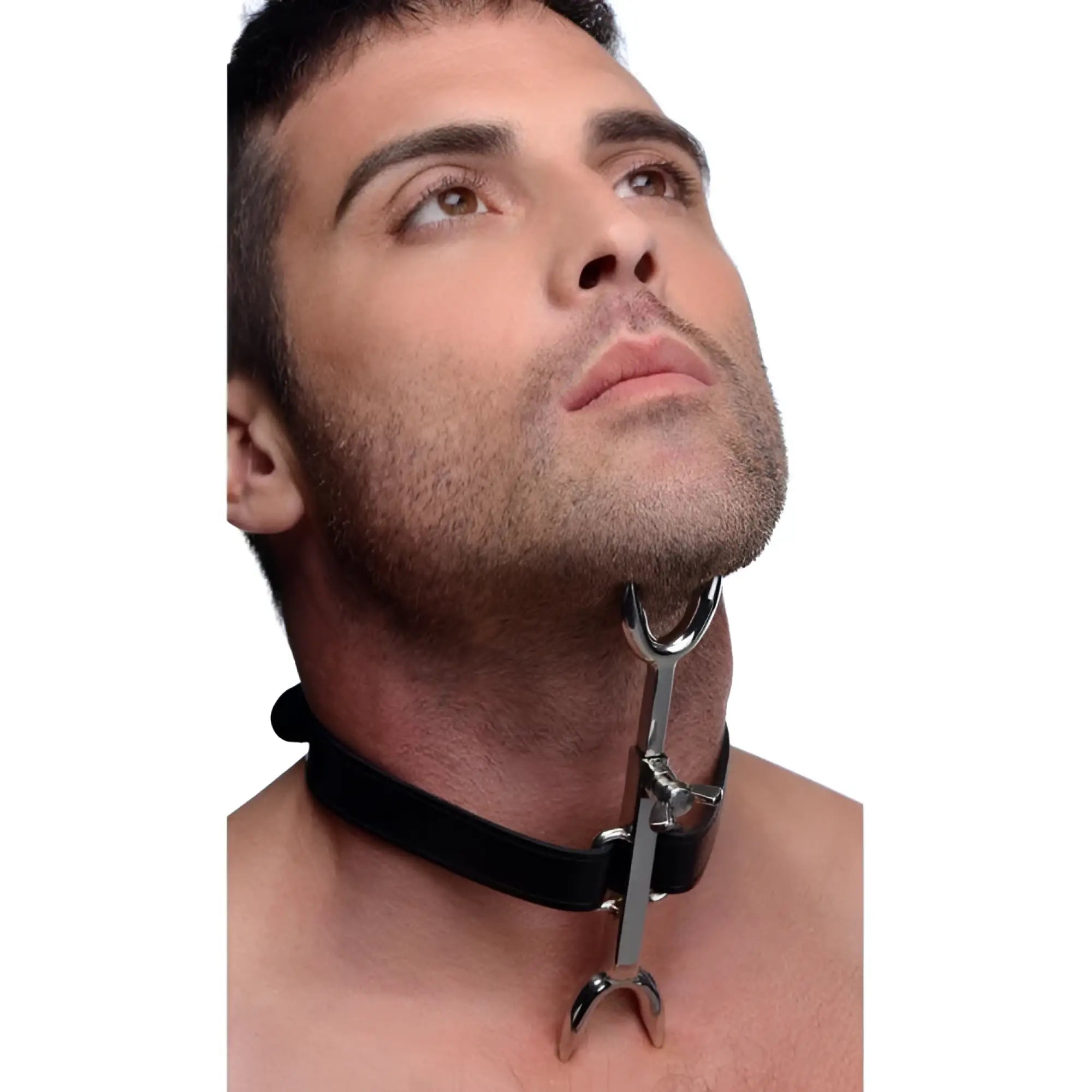 A man wearing a Strict Leather Heretics Fork, a silver metal neck restraint attached to a black leather collar.