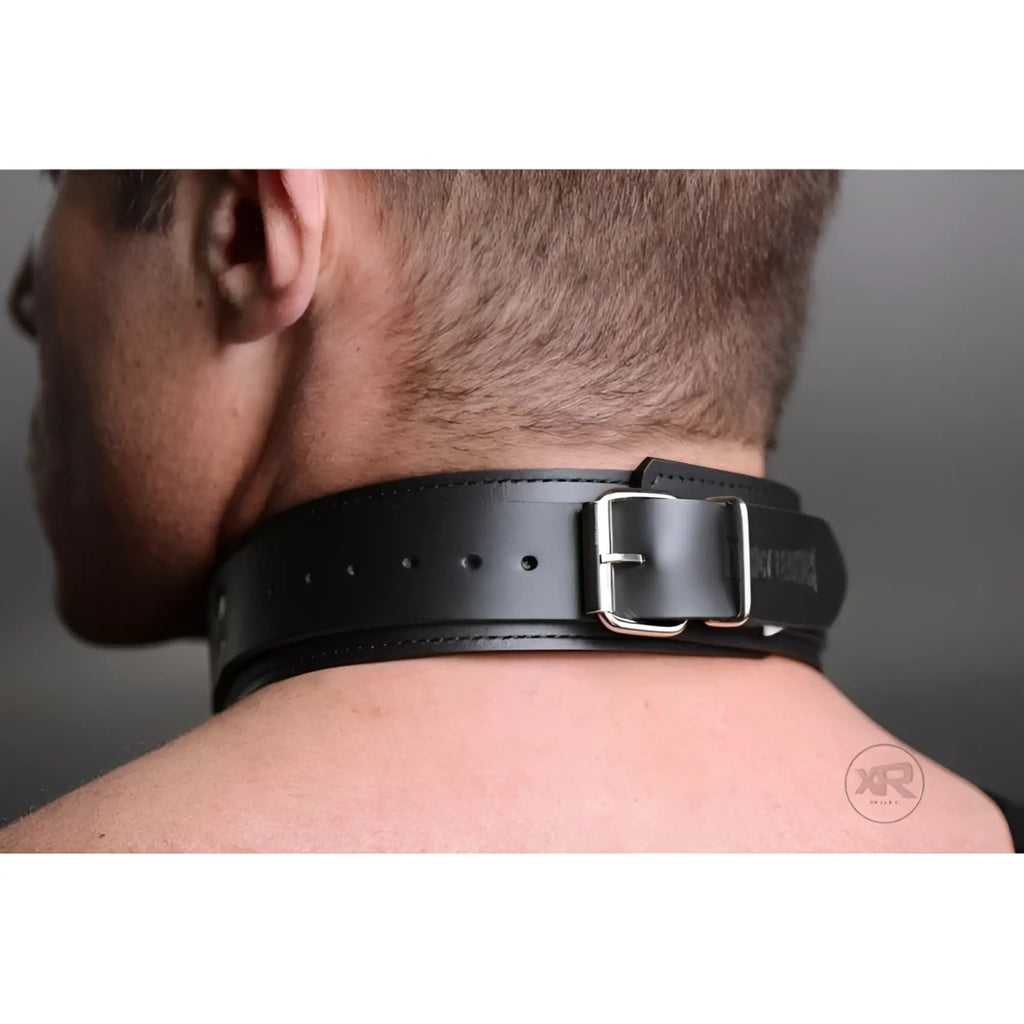 A person wears a black leather Strict Leather Lightweight Lined Collar with a silver buckle around their neck.
