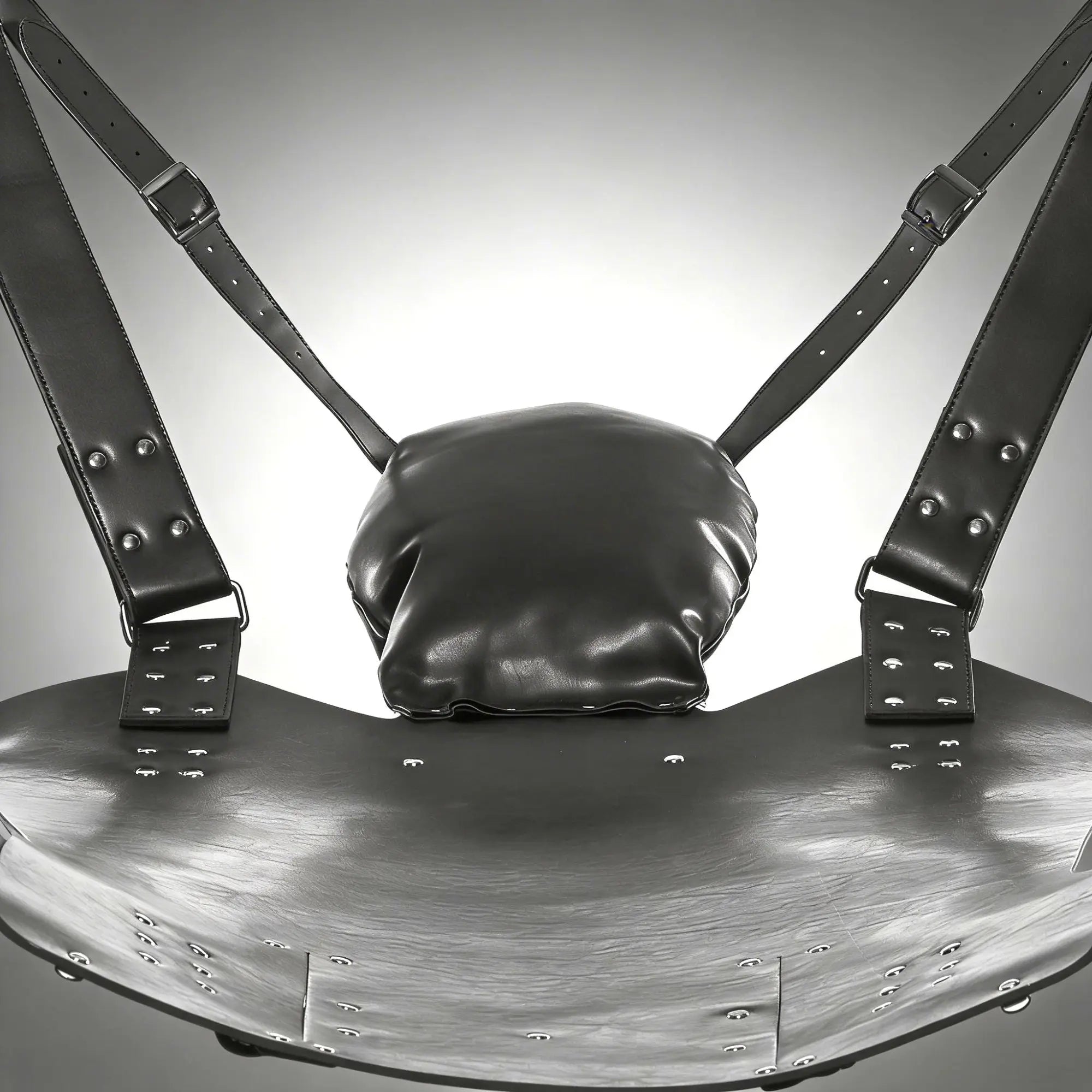 Strict Leather Lined Sling with black leather seat, adjustable buckled straps, rivets, and a cushioned headrest pillow.