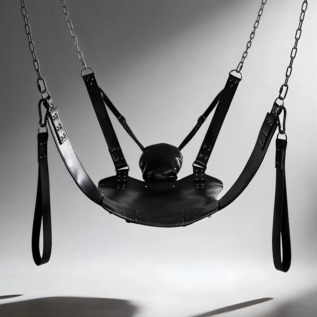 Strict Leather Lined Sling with black leather seat, integrated pillow, and hanging stirrups suspended by metal chains.