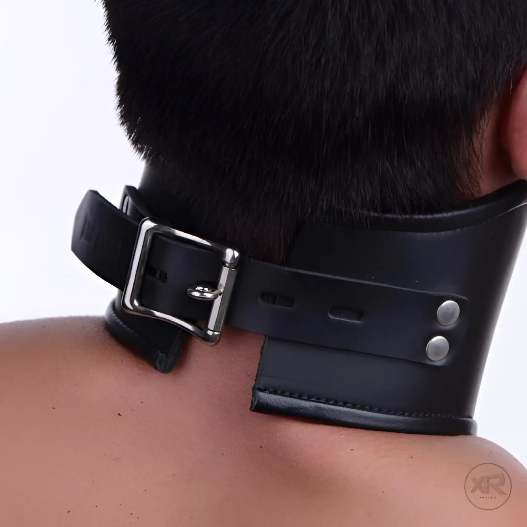 Strict Leather black leather lockable posture collar worn around a person's neck, featuring a silver buckle closure.