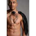 Strict Leather premium black deerskin flogger held over the shoulder by a shirtless man with a chest tattoo.