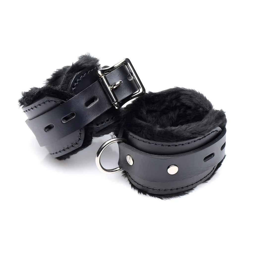 Strict Leather locking cuffs made of black leather with soft black faux fur lining, silver buckle, and metal D-ring.