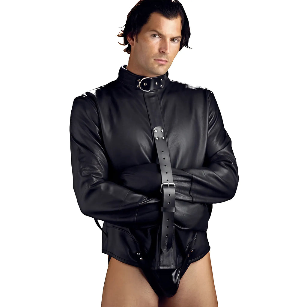 A man wearing a black Strict Leather premium leather straitjacket with long sleeves and a buckled strap closure.