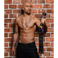 Strict Leather Rainbow Flogger: A shirtless man holding a metallic rainbow-colored multi-strand leather flogger.