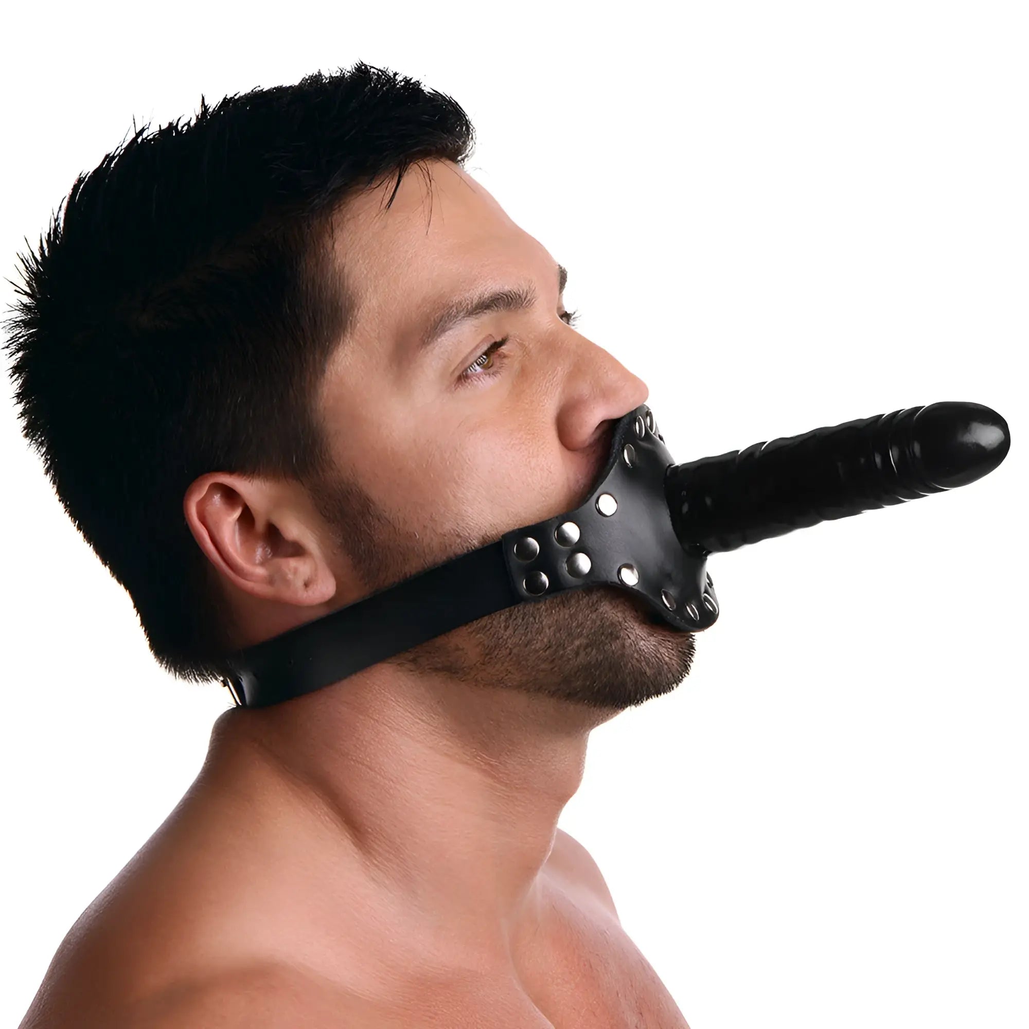 A man wearing a black leather "Ride Me" double dildo mouth gag with metal studs, isolated against a white background.
