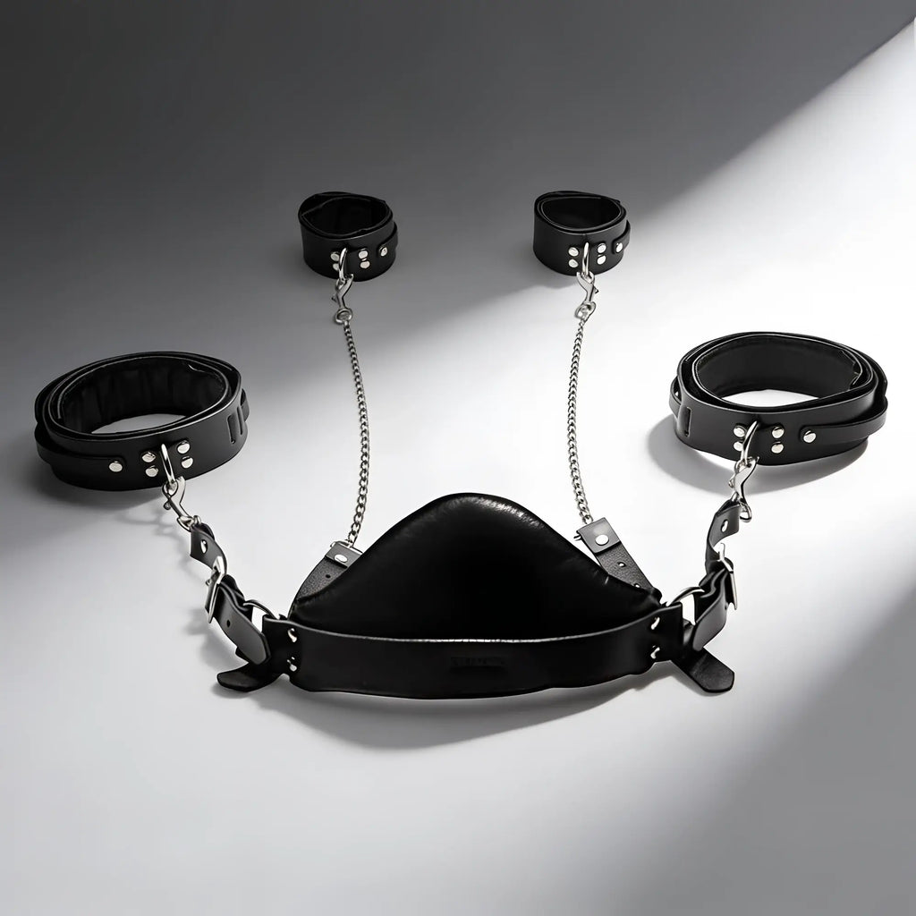 Strict Leather sling and stirrups: Black leather restraint set with silver chains, cuffs, and central support piece.