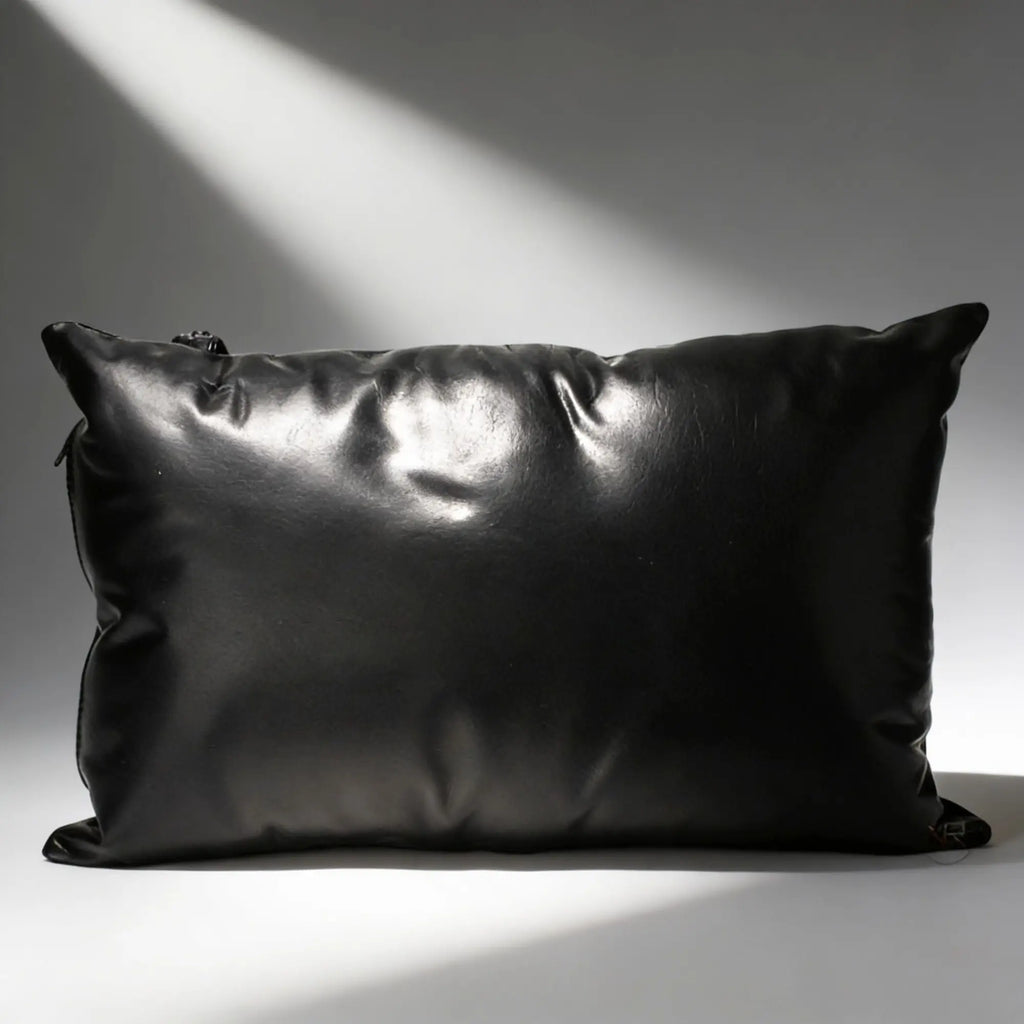 Strict Leather Sling pillow: a smooth, rectangular black leather pillow set against a grey background.